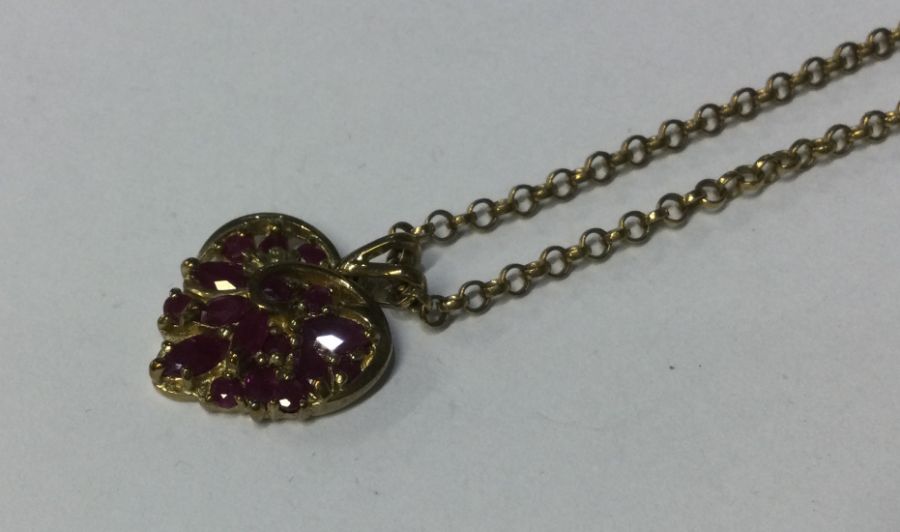 A 9 carat ruby heart shaped pendant with loop top.