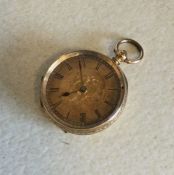 A small 18 carat gold fob watch. Est. £60 - £80.