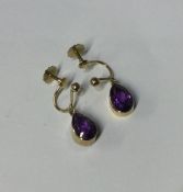 A pair of amethyst tear shaped earrings in gold mo