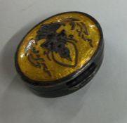 A silver and yellow enamelled oval pill box with f
