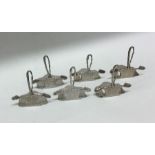 A good set of six silver menu holders in the form