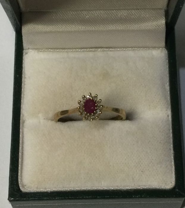 A 9 carat ruby and diamond cluster ring. Approx. 2