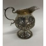 A good Georgian chased silver cream jug, the body