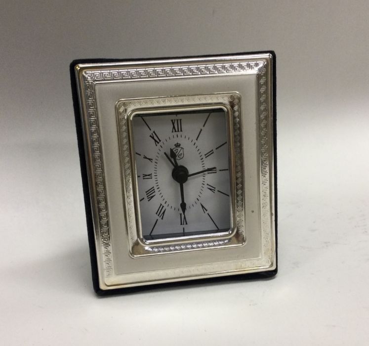A modern silver mounted mantle clock with felt bac