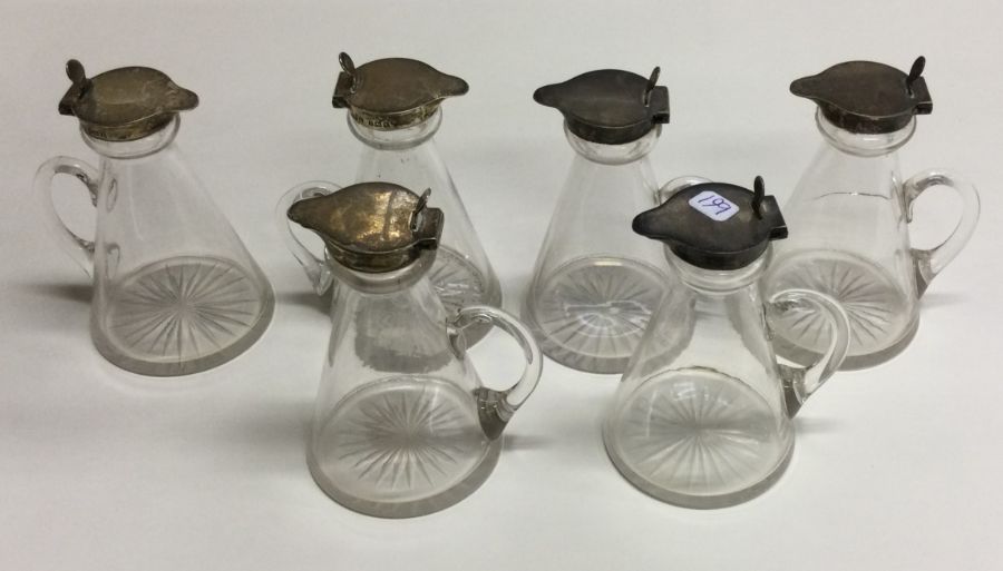 A rare set of six good silver mounted whisky noggi