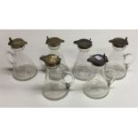 A rare set of six good silver mounted whisky noggi