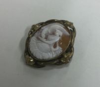 An oval cameo of a lady in scroll frame. Est. £20