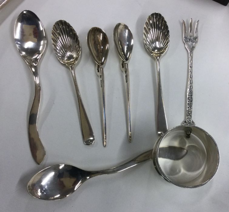 A collection of silver and other fruit spoons, nap