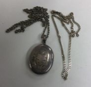 A Victorian silver locket on chain together with a