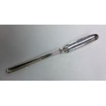 A silver double-ended marrow scoop with thread han