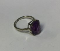 An amethyst single stone ring in white gold claw m