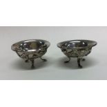 A pair of Chinese silver salts with dragon decorat