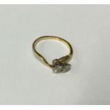 A diamond two stone crossover ring in 18 carat gol