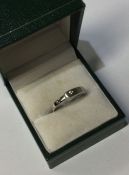 An unusual 9 carat buckle shaped ring with single