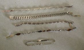 Five heavy silver bracelets. Est. £20 - £30.