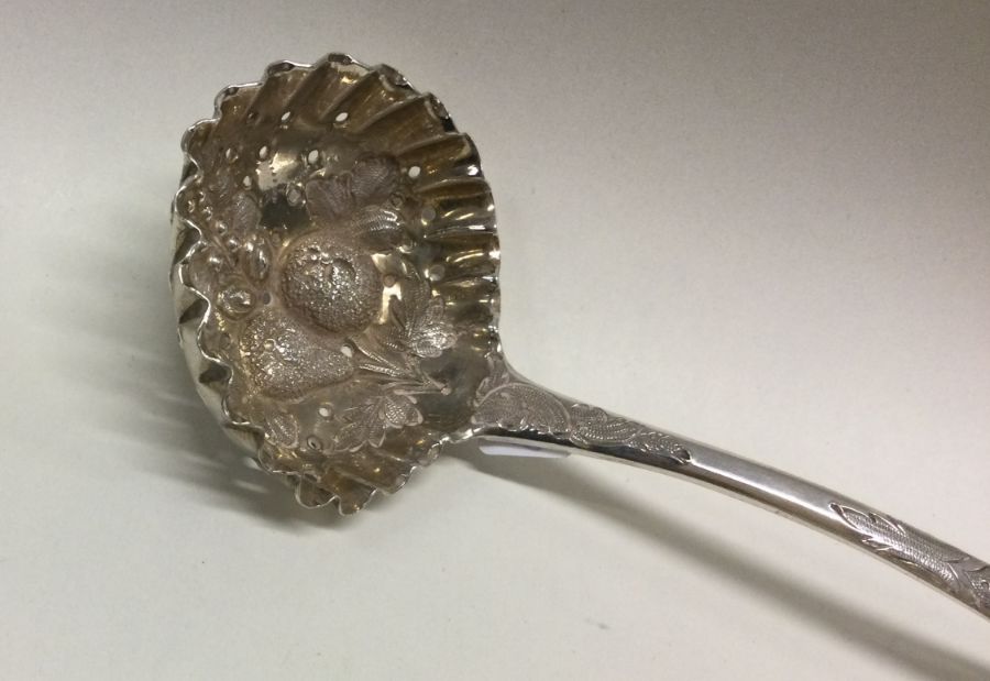 A pierced silver sauce ladle decorated with fruit. - Image 2 of 2