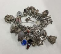 A heavy silver curb link charm bracelet. Approx. 5