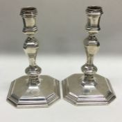 A heavy pair of Georgian style cast silver candles
