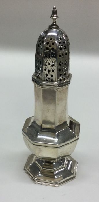 An octagonal silver sugar caster with pierced deco