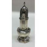 An octagonal silver sugar caster with pierced deco