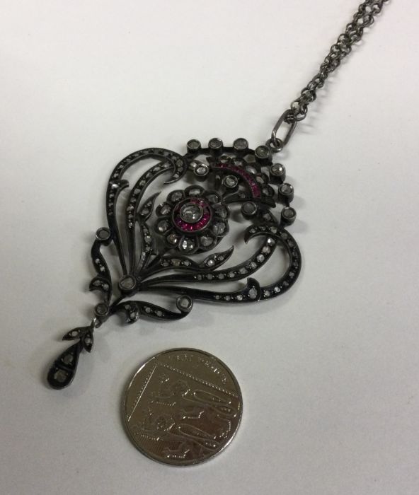 A large ruby and diamond drop pendant with scroll - Image 2 of 3