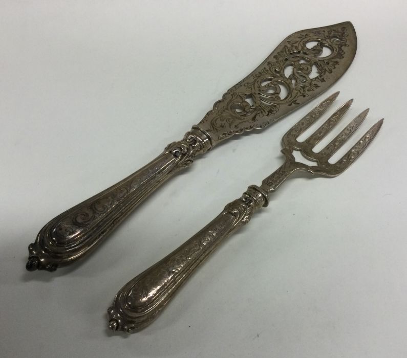 A pair of silver pierced fish servers of tapering