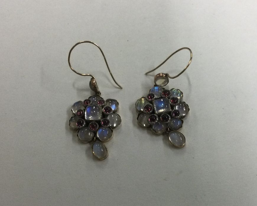 A good pair of moonstone earrings with loop tops s