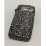 A large castle top silver cigar case decorated wit