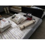 Black leatherette upholstered bed frame with striped British Bed Co. mattress, size 4'6'' double