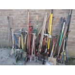 Large collection of various garden tools incl. forks, spades, rakes, loppers, and small green sack