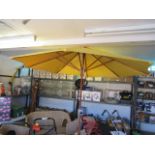 Yellow parasol with wooden pole