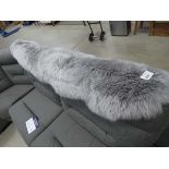 A grey sheepskin rug