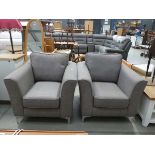 A pair of grey fabric armchairs