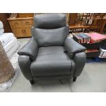 A grey leather effect electric reclining armchair