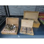 Cage containing three boxed sets of Bergeon watchmaker's tools