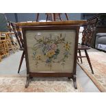 An embroidered fire screen