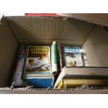 A box containing Rupert annuals and story books