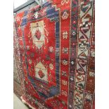 (34) Red Louis De Portier carpet with geometric and floral pattern