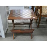 A folding teak chessboard table