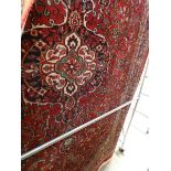 (28) An Iranian red floral carpet, 2 x 3m