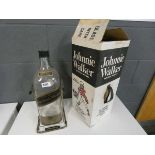 An empty Johnnie Walker Black Label bottle on swing stand