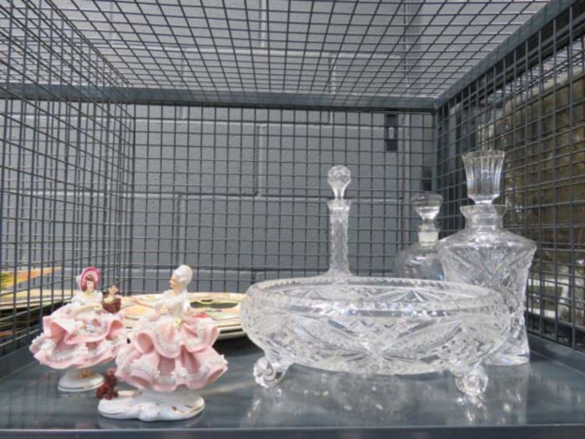 Cage containing 3 Royal Doulton character plates, decanters, and 2 Dresden figures