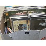 A box containing vinyl records and CD's