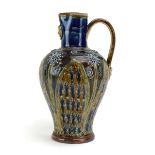 A Doulton Lambeth stoneware jug, the blue body decorated with green and pale blue flowers,