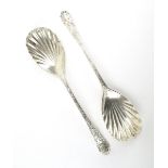 A pair of Victorian silver berry spoons with shell bowls and Rococo decoration, London 1896, l. 21.