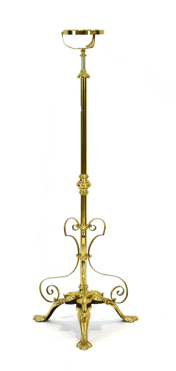 An Arts & Crafts brass adjustable standard oil-lamp holder with scrolls and foliate motifs,