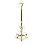 An Arts & Crafts brass adjustable standard oil-lamp holder with scrolls and foliate motifs,