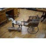 A late 19th/early 20th century oak and polychrome child's horse and trap with an adjustable seat,