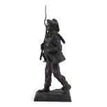 An early 20th century bronze figure modelled as a boy carrying his fishing equipment,