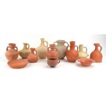 Twelve items of archaic unglazed pottery comprising nine jars, a cup and two dishes, max h.